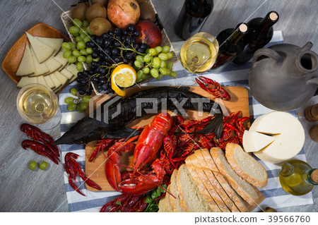 Top view of smoked sturgeon, lobster, crayfishes, bread, cheese, fruits and wine 39566760