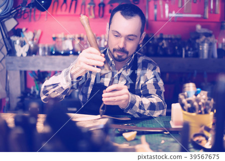 Hard-working man working on belt leather Hard-working man working on belt leather 39567675