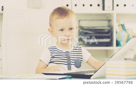 Kid is playing on laptop 39567798