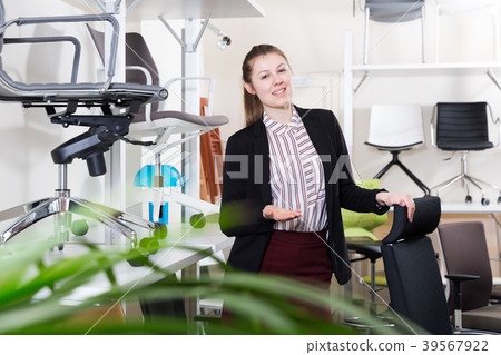 Saleswoman welcoming to chair store Saleswoman welcoming to chair store 39567922
