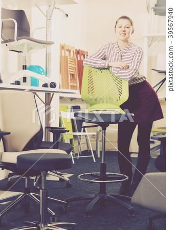Smiling girl standing in chair shop Smiling girl standing in chair shop 39567940