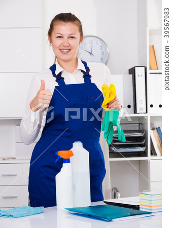 Woman in uniform is satisfied after cleaning Woman in uniform is satisfied after cleaning 39567983