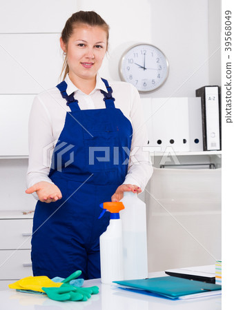Female office cleaner is talking while cleaning the cabinet 39568049