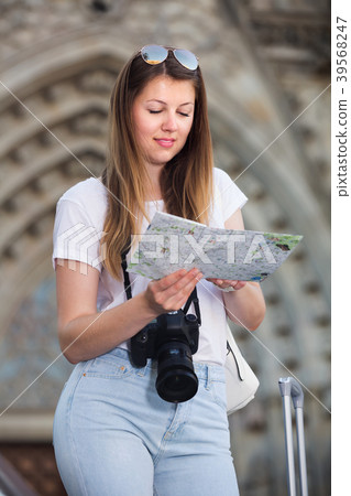 Positive girl holding map in hands outdoor Positive girl holding map in hands outdoor 39568247