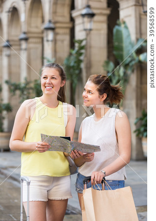 Women holding map and searching for the direction 39568599