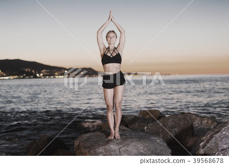 Adult woman is practicing stretching Adult woman is practicing stretching 39568678