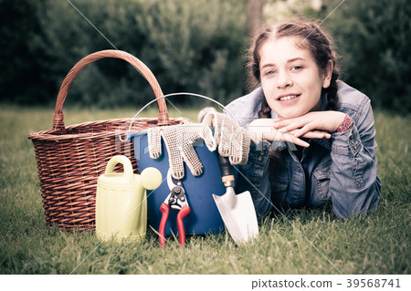 female with gardening tools while lying in park 39568741