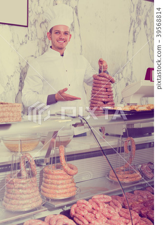 Happy man seller working at meat market Happy man seller working at meat market 39568814