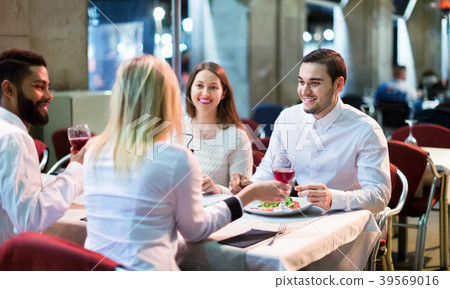 Portrait of happy adults having dinner outdoors 39569016