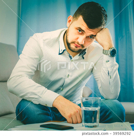 Man feeling distressed and lonely alone at home Man feeling distressed and lonely alone at home 39569292