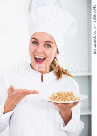 portrait of young coosie woman showing mush at kitchen portrait of young coosie woman showing mush at kitchen 39569340