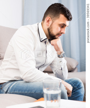 Sad young male spending day alone Sad young male spending day alone 39569341