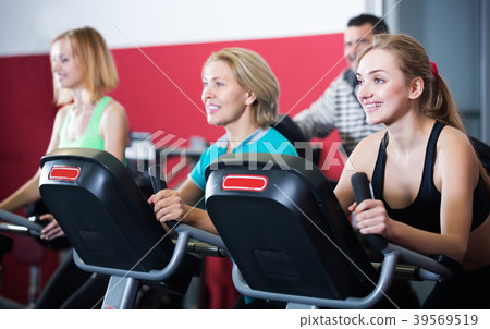Fitness group riding stationary bicycles Fitness group riding stationary bicycles 39569519