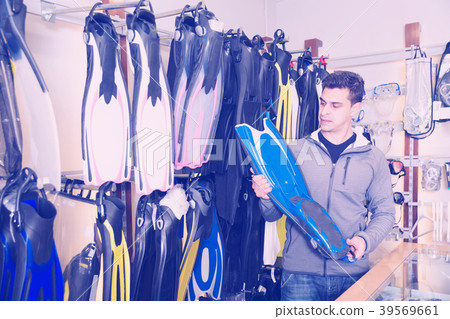 guy is choosing new flippers for diving guy is choosing new flippers for diving 39569661