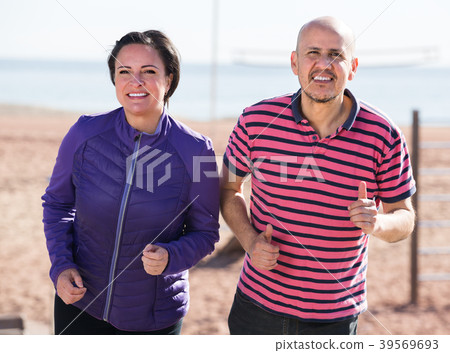 Mature couple jogging together . 39569693