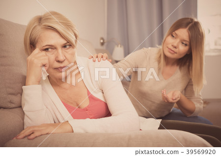 daughter comforts a sad mother daughter comforts a sad mother 39569920