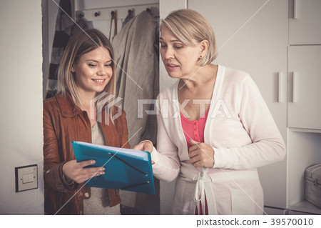 daughter shows some documents of her mother daughter shows some documents of her mother 39570010