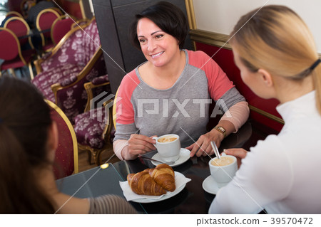 Three woman sitting in cafe Three woman sitting in cafe 39570472