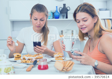 friends drinking tea with mobile phone friends drinking tea with mobile phone 39570614