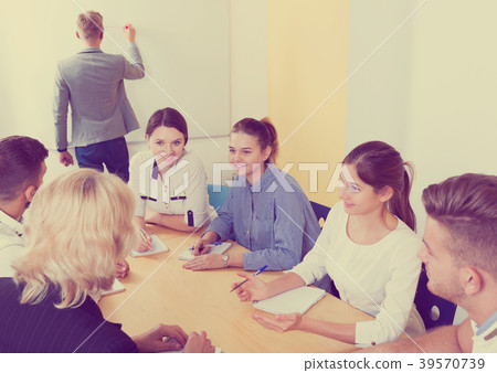 positive students working together in auditorium 39570739