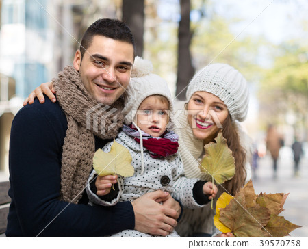 Mom, dad and daughter posing outdoor 39570758