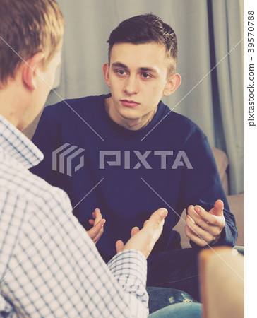 Man with his adult son are serious talking about life together 39570788