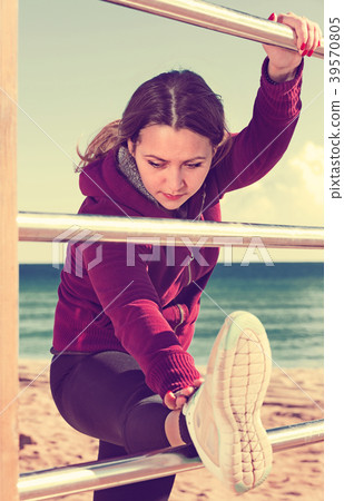 Sporty woman exercising at sea beach 39570805