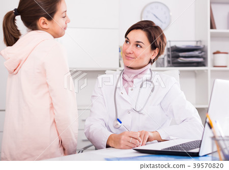 Doctor fills patient card for girl Doctor fills patient card for girl 39570820