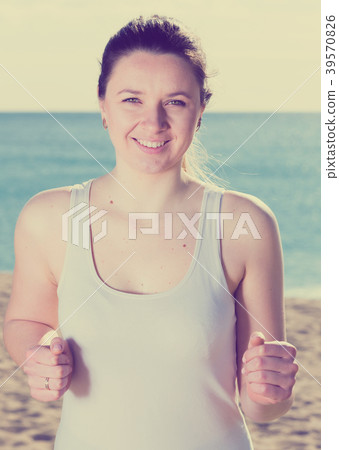 Woman running on beach Woman running on beach 39570826