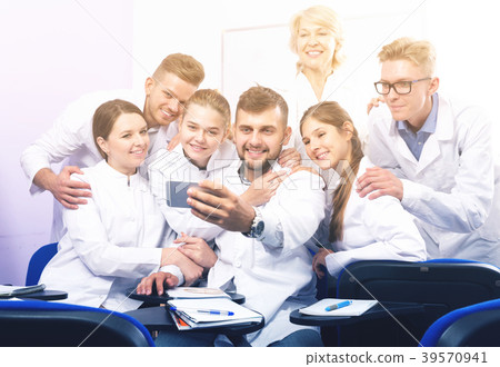 Positive students making selfie indoors 39570941
