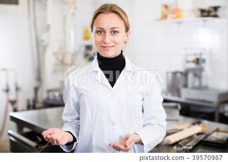 Woman working in modern food factory Woman working in modern food factory 39570987
