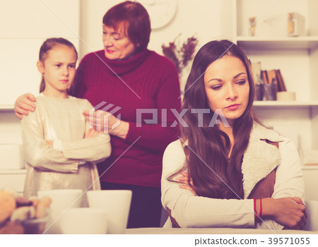 Upset woman after quarrel with family Upset woman after quarrel with family 39571055