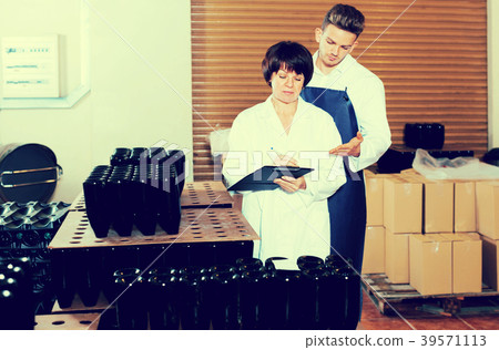 Employees checking number of wine bottles Employees checking number of wine bottles 39571113