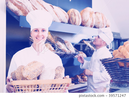 Bakers man and woman are with tasty and fresh bread products Bakers man and woman are with tasty and fresh bread products 39571247