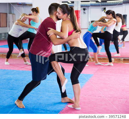 Girl is doing self-defence moves with coach Girl is doing self-defence moves with coach 39571248