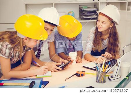 Boys and girls architects with plan 39571297