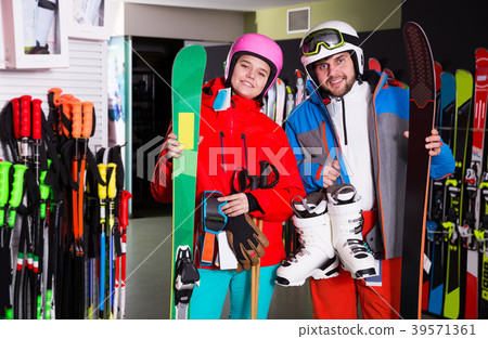 guy and girl posing in full skiing gear guy and girl posing in full skiing gear 39571361