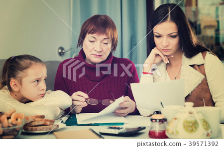 Upset family with documents at home 39571392