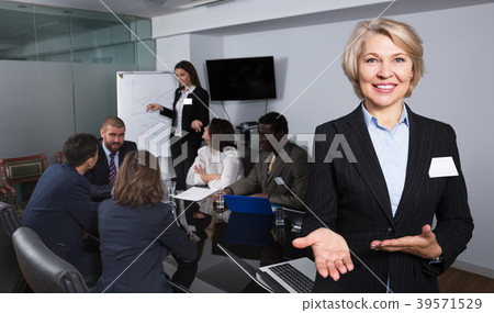 Woman with team in boardroom 39571529