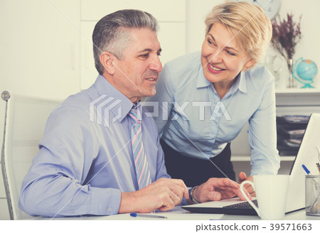 Colleagues look interesting in computer 39571663