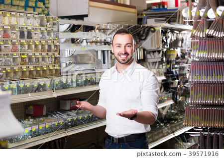 Man picking plastic dowel 39571916