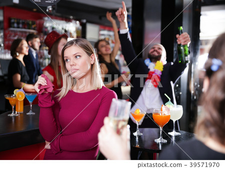Offended woman with drunk man on party at nightclub Offended woman with drunk man on party at nightclub 39571970
