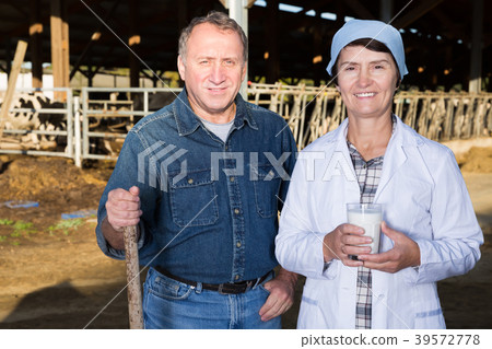 Ordinary couple farmers standing at workplace 39572778
