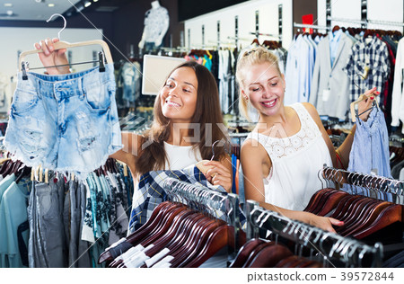 Women choosing jeans shorts Women choosing jeans shorts 39572844