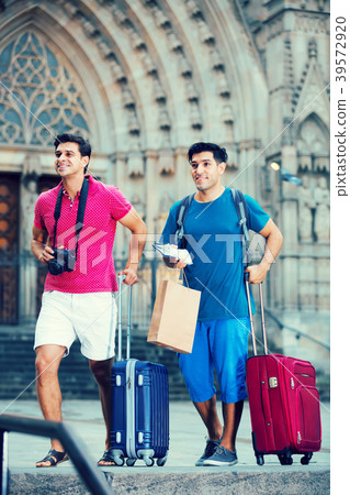 Men tourists walking with suitcases Men tourists walking with suitcases 39572920