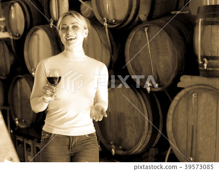 Woman having glass of wine in wine house Woman having glass of wine in wine house 39573085