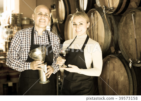 Happy man and female posing with wine from wood Happy man and female posing with wine from wood 39573158