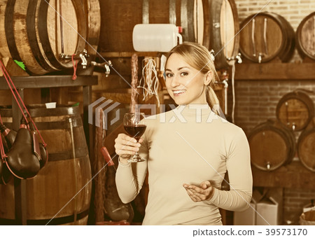 Woman having glass of wine in wine house Woman having glass of wine in wine house 39573170