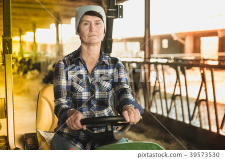 Female farm owner on tractor Female farm owner on tractor 39573530