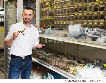 Man selecting metallic faucet 39573746
